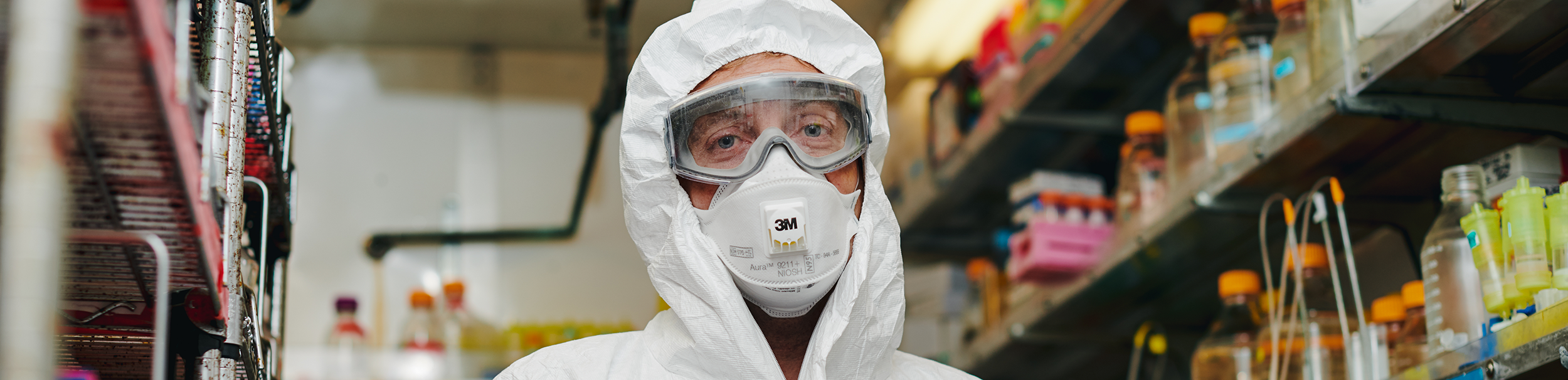 Researcher in a lab, in full safety gear