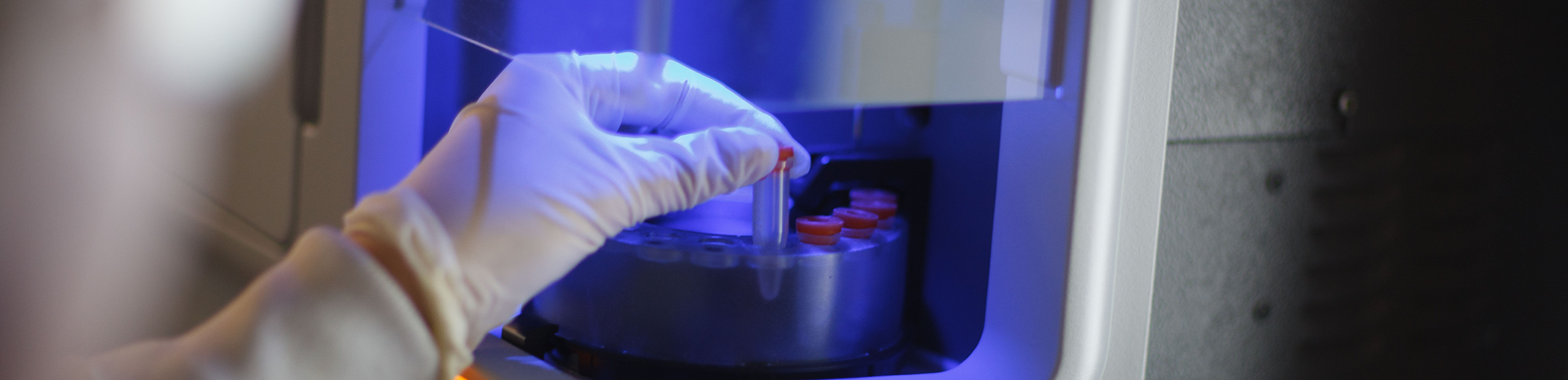 Researcher's hand in a lab using the tools