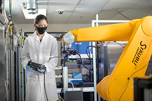 scientist using a big machine in a lab